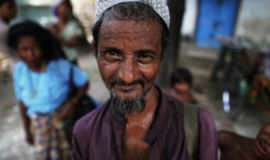 Seorang warga etnis Rohingya tengah menunggu bantuan diluar sebuah masjid di Sittwe, Myanmar. (Damir Sagolj/Reuters)